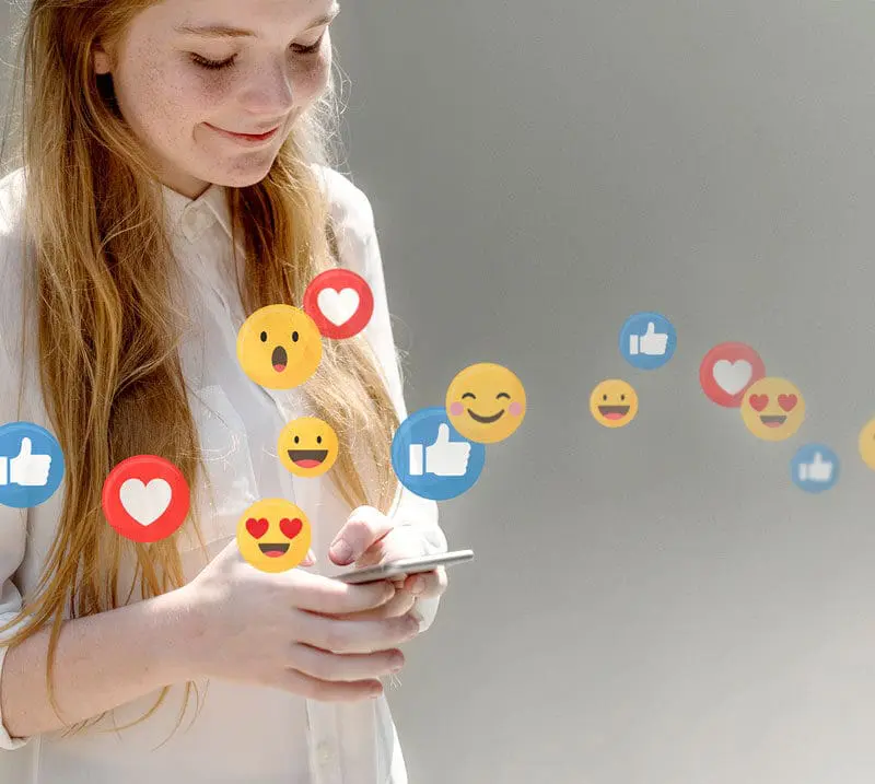 User engaging with social media content on a smartphone with likes and reactions representing social media marketing strategy