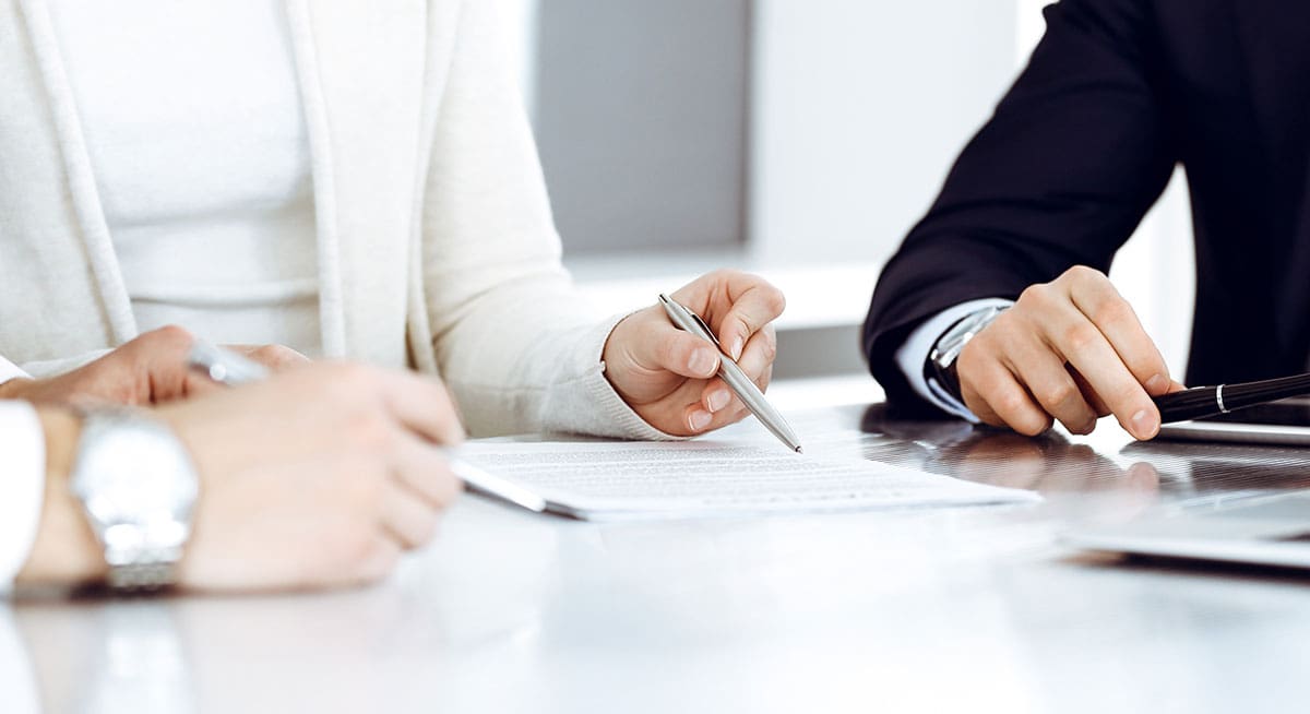 Legal professionals reviewing documents during a consultation focused on secure and professional website design