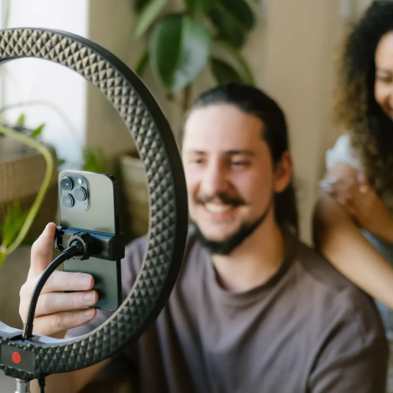 Inhouse Designer, Talana, and Jnr Social Media Managaer, Jacques, taking vidoes on an iphone for reels and tiktoks doing trends for social media