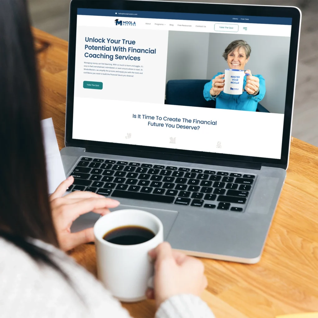 Moola Masters financial coaching website displayed on a laptop during an online learning session