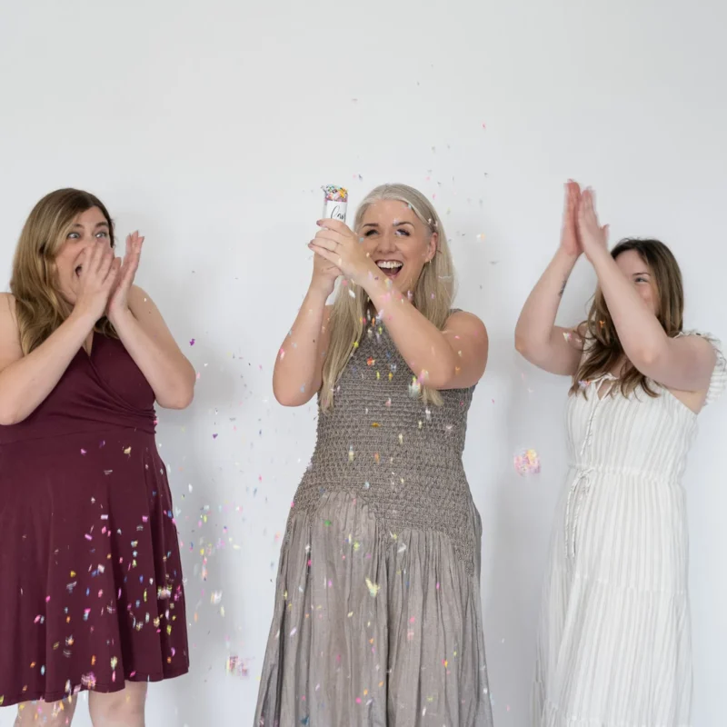 Team celebrating a milestone with confetti and shared excitement