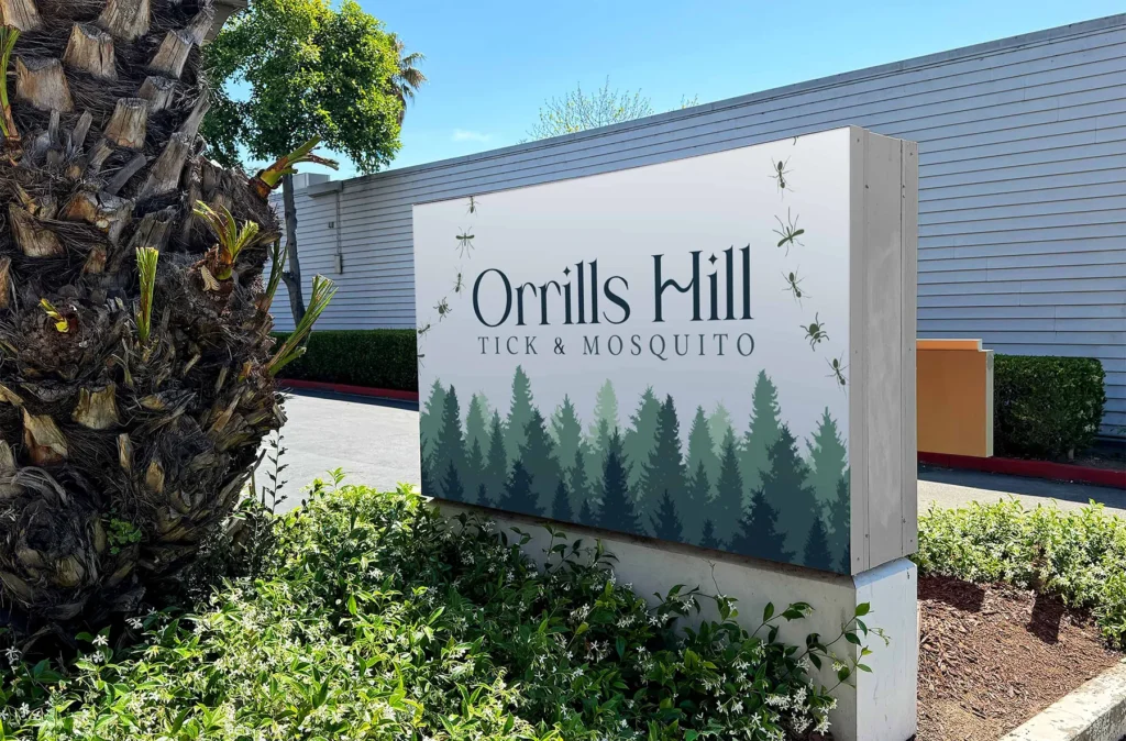 Orrills Hill Tick and Mosquito outdoor sign displayed at a landscaped commercial property