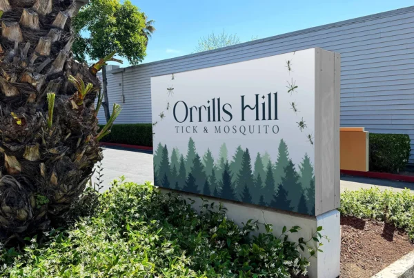 Orrills Hill Tick and Mosquito outdoor sign displayed at a landscaped commercial property