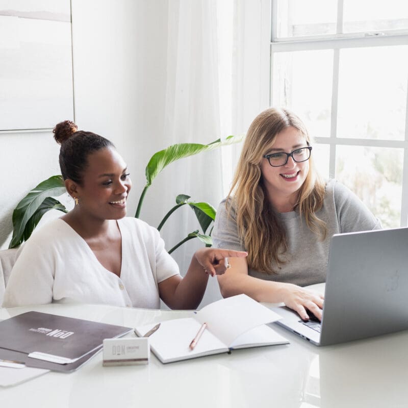 Team collaborating on logistics website development and SEO strategy using a laptop and planning materials