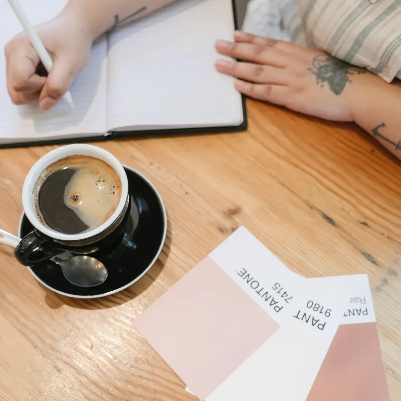 Creative professional writing strategy notes beside coffee and brand color swatches