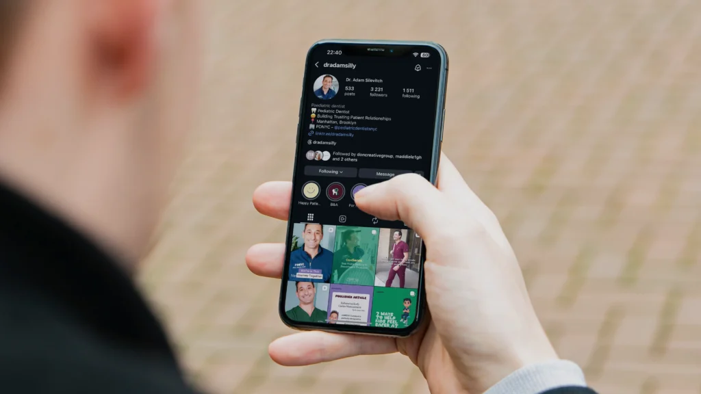 Person viewing a professional Instagram profile on a smartphone during social media planning