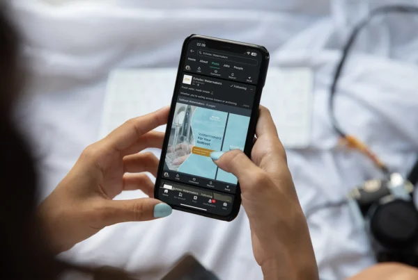 Person holding a smartphone viewing ECHOTec Watermakers social media post about sailboat watermakers