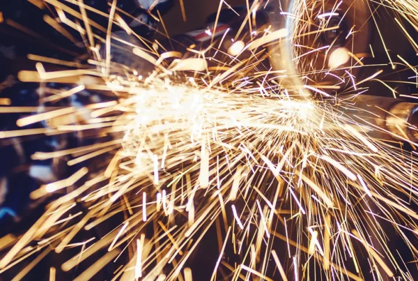 Metal cutting process creating sparks during industrial fabrication work