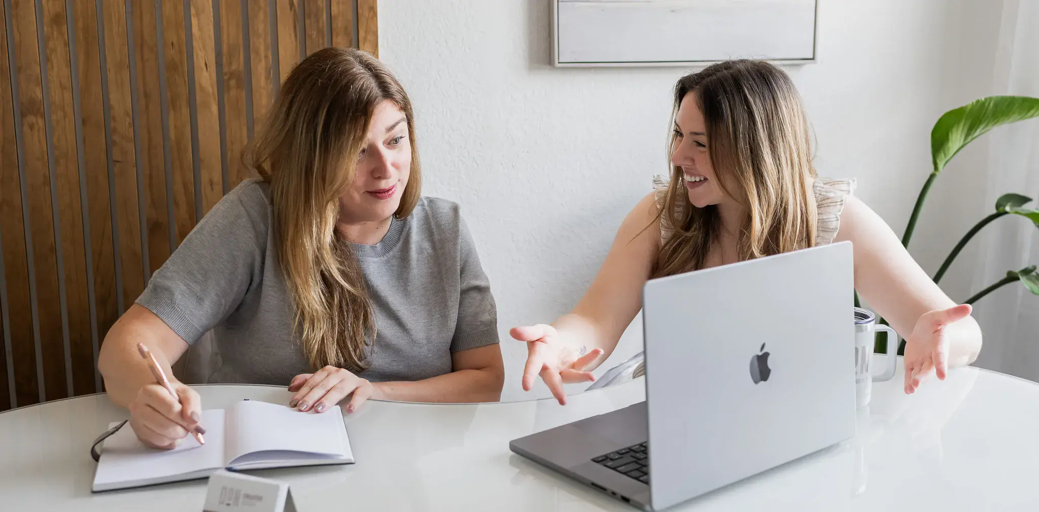 Team member holding laptop displaying logistics company website during client review